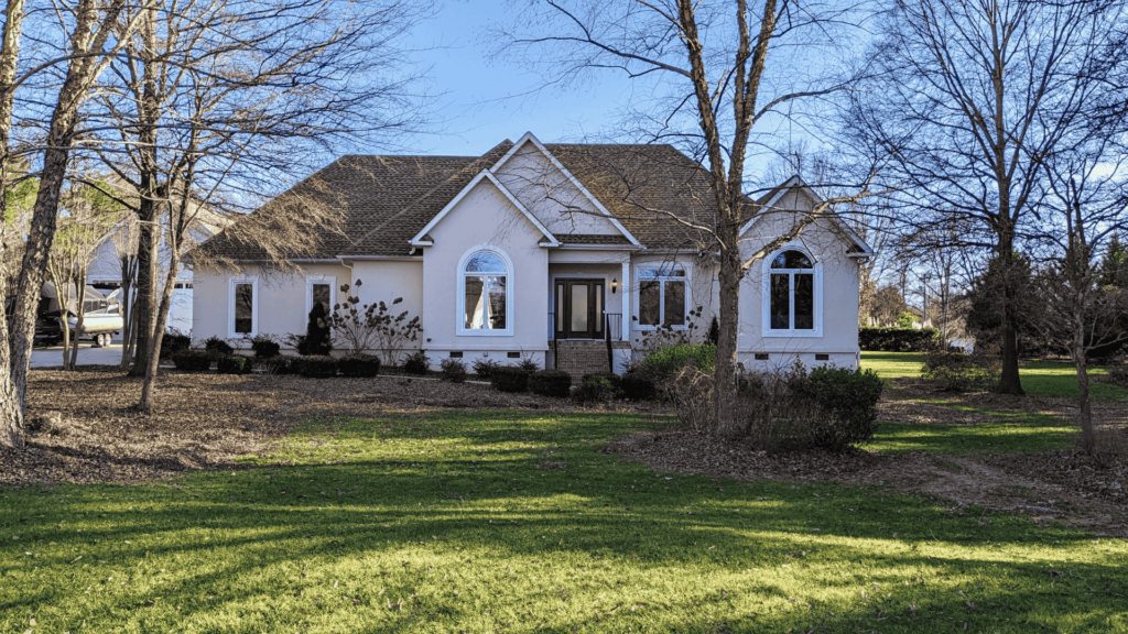Modern home with a spacious front yard, offered by Alexander Realty and Construction LLC for home buyers.
